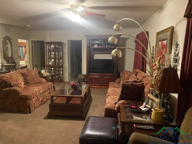 living room with crown molding, ceiling fan, light colored carpet, and a textured ceiling