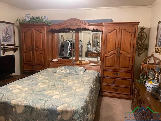 carpeted bedroom featuring crown molding