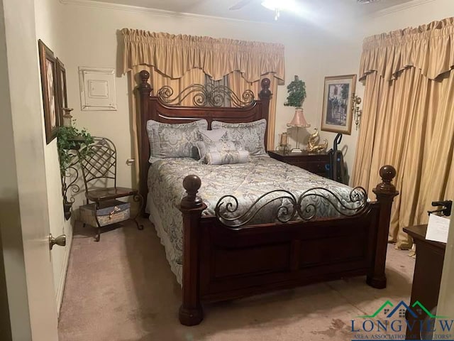 carpeted bedroom with ceiling fan and crown molding