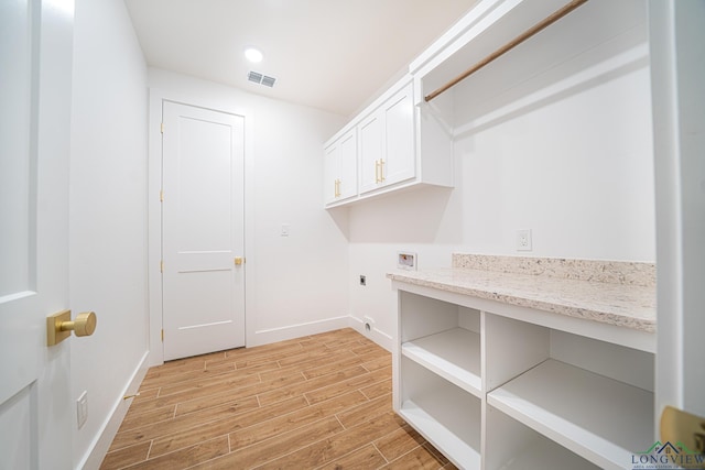 washroom featuring hookup for a washing machine, cabinets, and hookup for an electric dryer