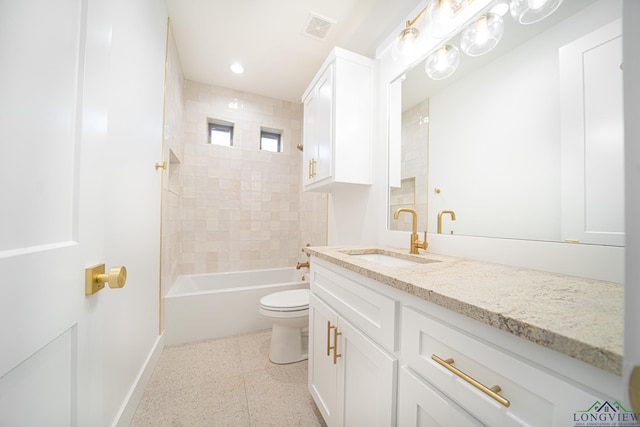 full bathroom with vanity, toilet, and tiled shower / bath