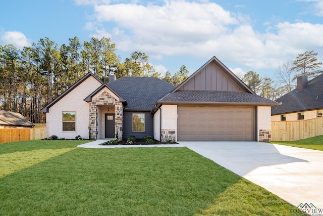 view of front of property featuring a front yard and a garage