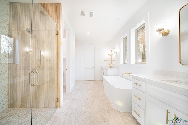 bathroom featuring vanity and separate shower and tub