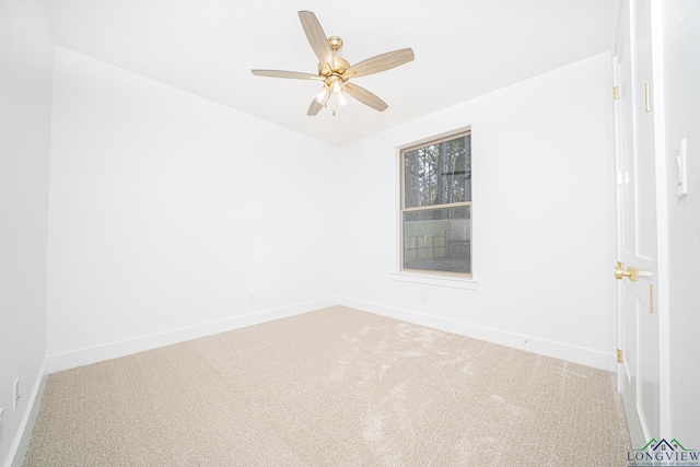 empty room featuring ceiling fan and carpet