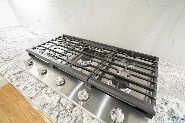 interior details with hardwood / wood-style flooring and stainless steel gas stovetop