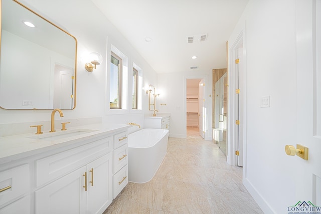 bathroom with vanity and independent shower and bath