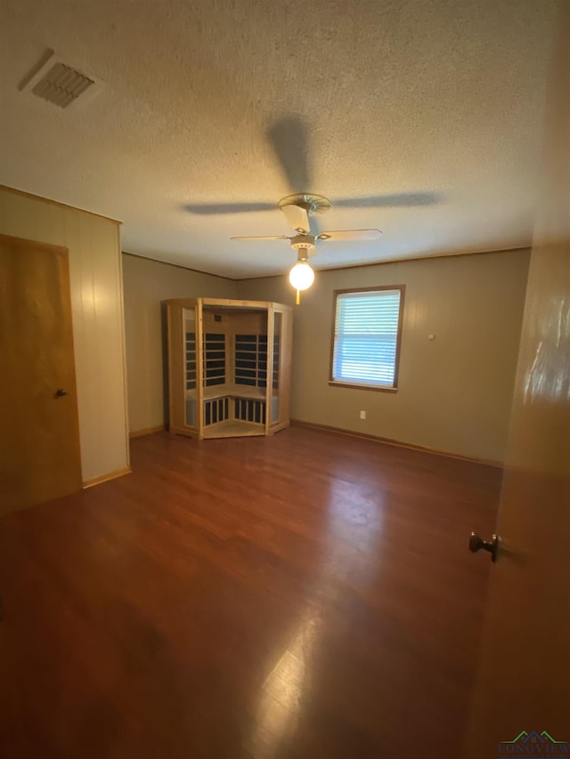 interior space with ceiling fan and a textured ceiling