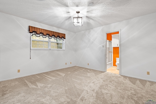 4 Briar Ln, Kilgore, TX 75662 - carpeted spare room featuring baseboards and a textured ceiling