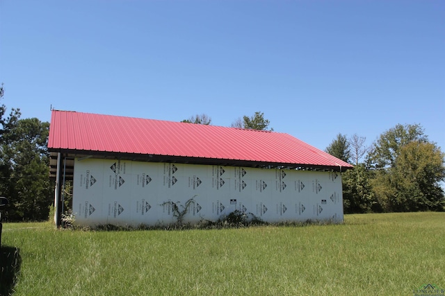 view of side of home featuring a lawn