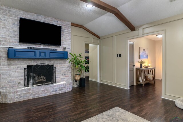 1317 Tiffany Ln, Longview, TX 75604 - living area with lofted ceiling, wood finished floors, a fireplace, baseboards, and a textured ceiling