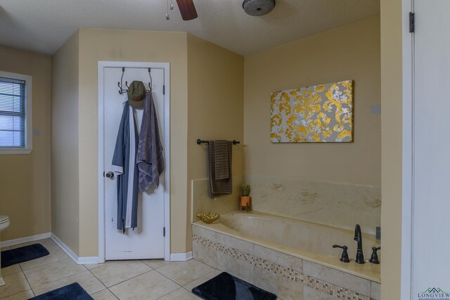 1317 Tiffany Ln, Longview, TX 75604 - full bath with tile patterned floors, toilet, a garden tub, and a ceiling fan