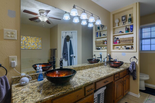 1317 Tiffany Ln, Longview, TX 75604 - full bath featuring toilet, tile patterned floors, double vanity, and ceiling fan