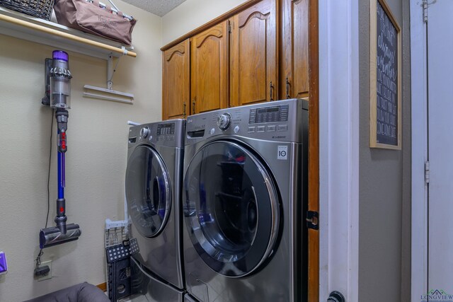 1317 Tiffany Ln, Longview, TX 75604 - laundry area featuring cabinet space and washer and clothes dryer