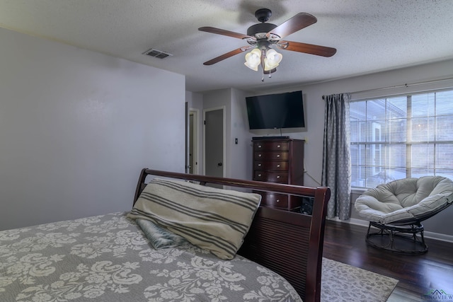 1317 Tiffany Ln, Longview, TX 75604 - bedroom featuring wood finished floors, a textured ceiling, and ceiling fan