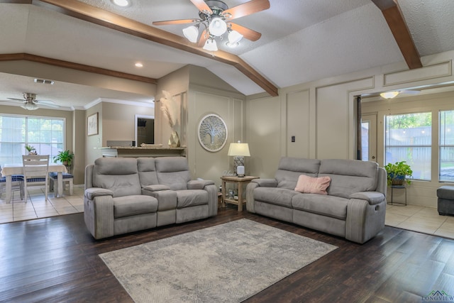 1317 Tiffany Ln, Longview, TX 75604 - living area featuring a ceiling fan, wood finished floors, a decorative wall, vaulted ceiling, and a textured ceiling