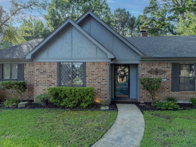 1317 Tiffany Ln, Longview, TX 75604 - single story home featuring a front yard, a chimney, brick siding, and a shingled roof