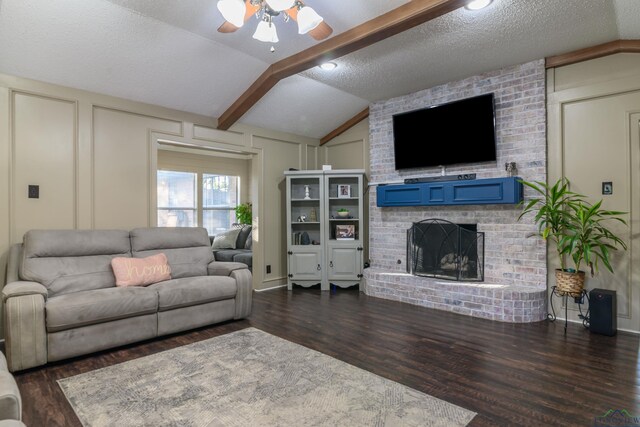 1317 Tiffany Ln, Longview, TX 75604 - living area featuring lofted ceiling, a brick fireplace, dark wood-style floors, a ceiling fan, and a decorative wall