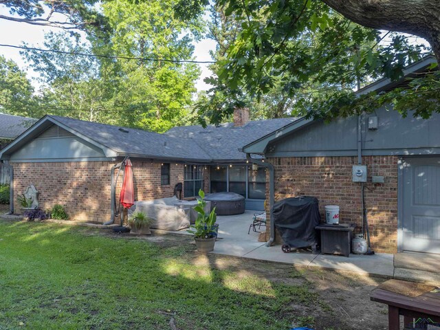 1317 Tiffany Ln, Longview, TX 75604 - back of property featuring brick siding, a patio, a yard, a chimney, and a shingled roof