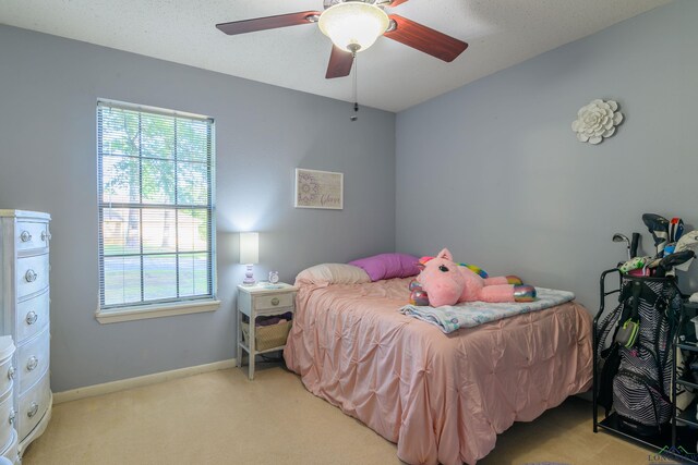 1317 Tiffany Ln, Longview, TX 75604 - carpeted bedroom featuring multiple windows, a ceiling fan, and baseboards