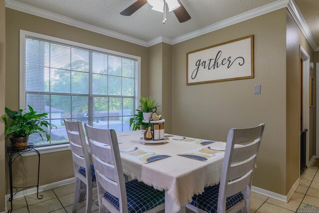 1317 Tiffany Ln, Longview, TX 75604 - dining area featuring healthy amount of natural light, light tile patterned floors, crown molding, ceiling fan, and a textured ceiling