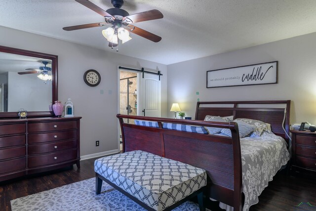 1317 Tiffany Ln, Longview, TX 75604 - bedroom featuring a barn door, wood finished floors, baseboards, a ceiling fan, and a textured ceiling