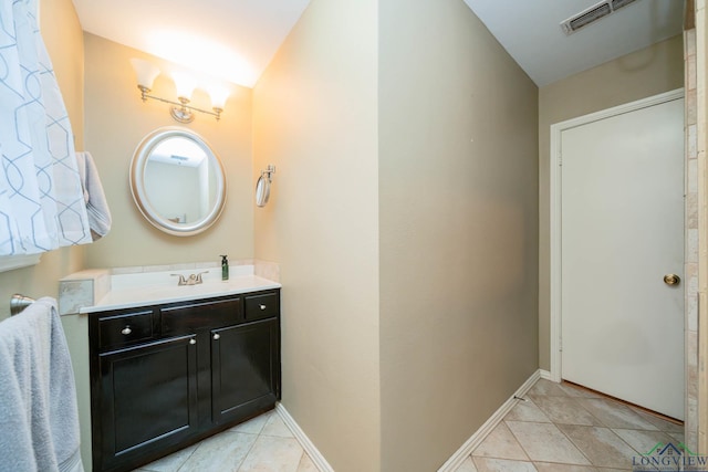 bathroom featuring tile patterned floors, visible vents, baseboards, and vanity