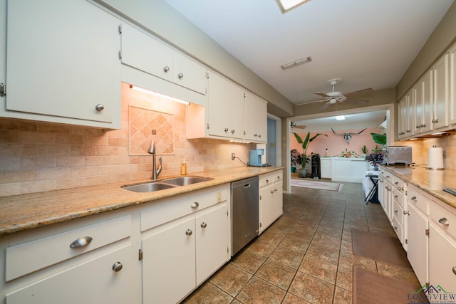 kitchen featuring visible vents, ceiling fan, stainless steel dishwasher, white cabinetry, and a sink