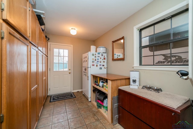 doorway to outside featuring light tile patterned flooring