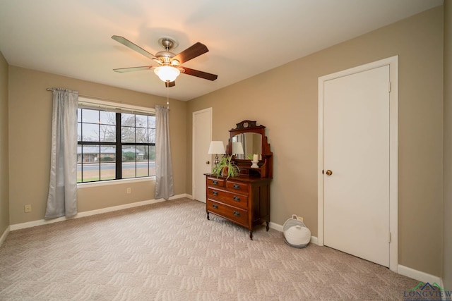 bedroom with light colored carpet, baseboards, and ceiling fan