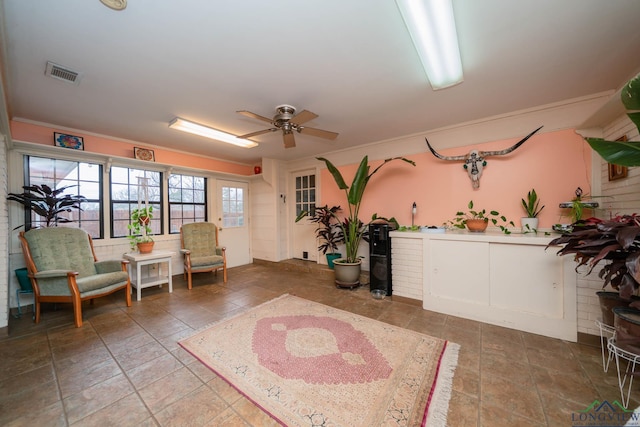 living area with visible vents and a ceiling fan