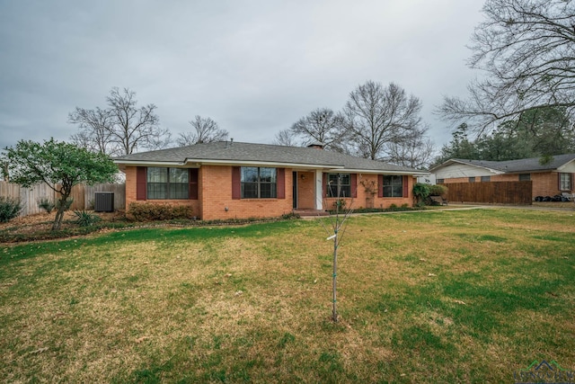 single story home featuring brick siding, central AC, a front lawn, and fence