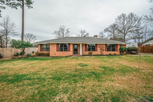 ranch-style house with a front lawn, fence, brick siding, and a chimney