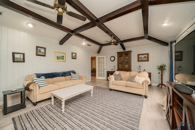 living area featuring light wood-type flooring, beam ceiling, visible vents, and a ceiling fan