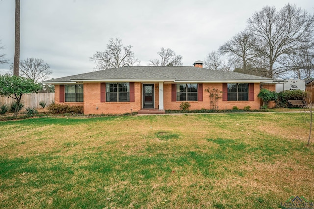 single story home with a front lawn, fence, brick siding, and a chimney