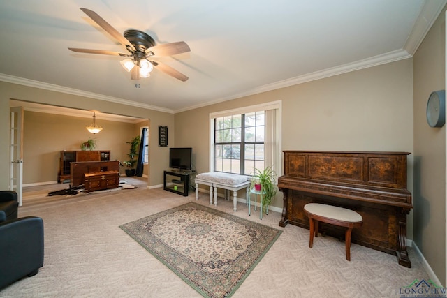 carpeted living area with ceiling fan, baseboards, and ornamental molding