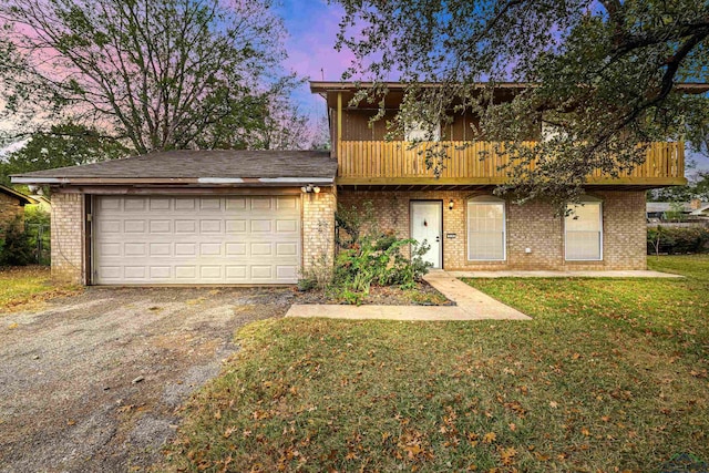 front of property featuring a yard and a garage