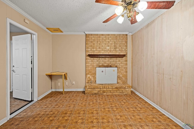 unfurnished living room featuring ceiling fan, tile patterned flooring, crown molding, a textured ceiling, and wooden walls