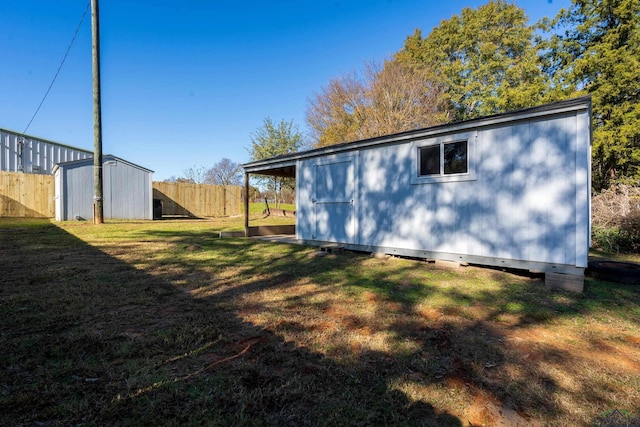 view of home's exterior with a lawn and a shed