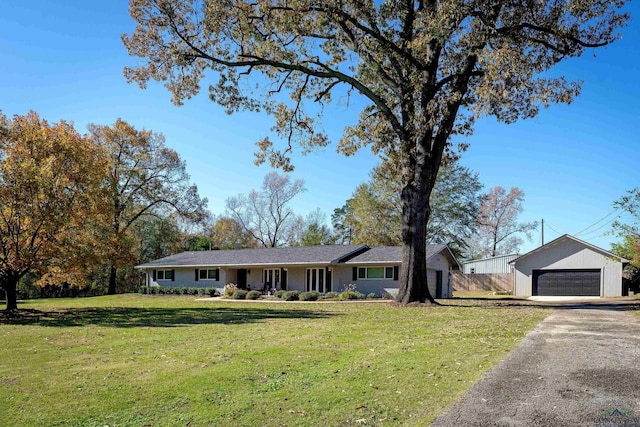 ranch-style house featuring an outdoor structure, a front yard, and a garage