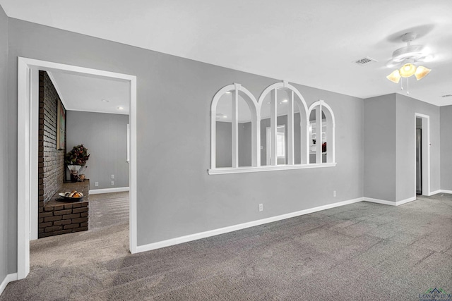 spare room featuring ceiling fan and carpet