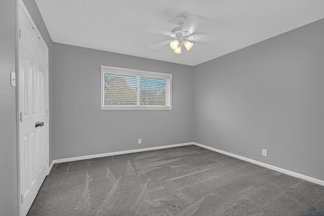 carpeted spare room featuring ceiling fan