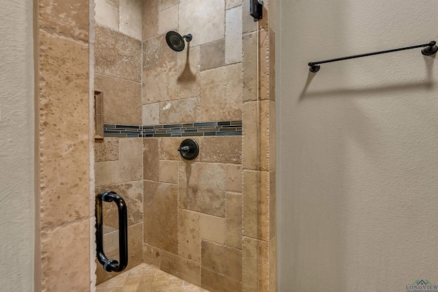 1624 Olympic Dr, Longview, TX 75605 - bathroom featuring tiled shower and a textured wall