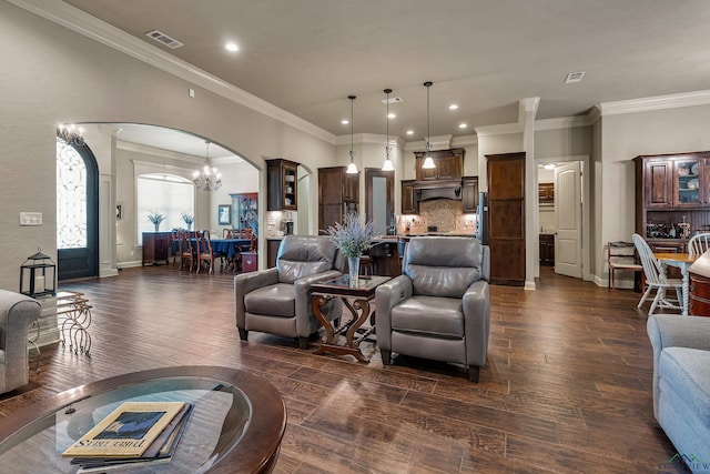 1624 Olympic Dr, Longview, TX 75605 - living room with arched walkways, a chandelier, ornamental molding, dark wood-style flooring, and recessed lighting
