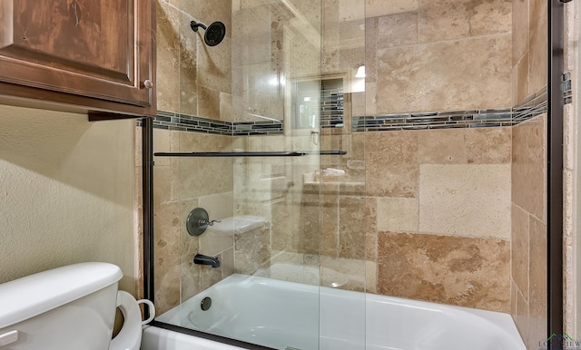 1624 Olympic Dr, Longview, TX 75605 - bathroom featuring bath / shower combo with glass door, toilet, and a textured wall