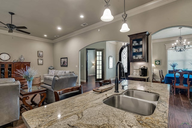 1624 Olympic Dr, Longview, TX 75605 - kitchen with arched walkways, open floor plan, a sink, dark wood finished floors, and crown molding