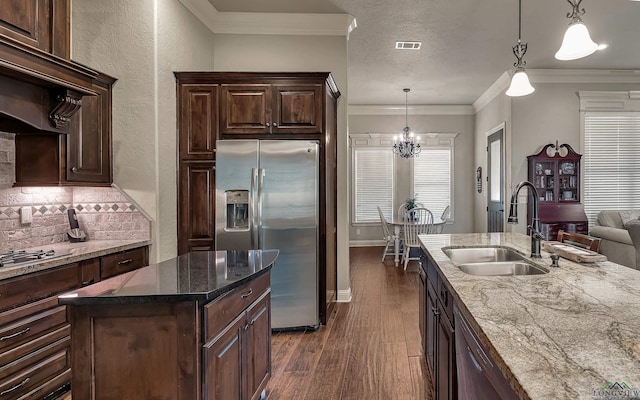 1624 Olympic Dr, Longview, TX 75605 - kitchen featuring appliances with stainless steel finishes, a sink, dark wood-type flooring, backsplash, and dark brown cabinets