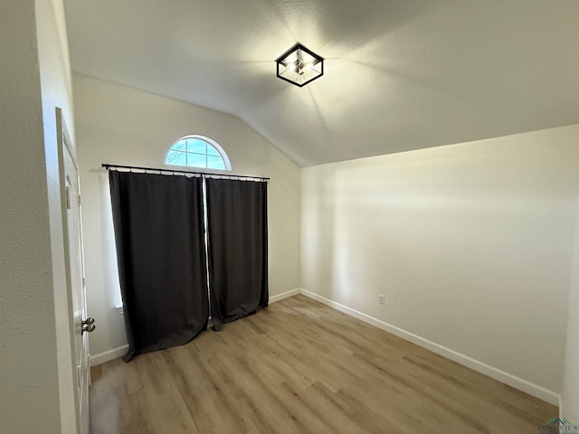 interior space with lofted ceiling and light wood-type flooring