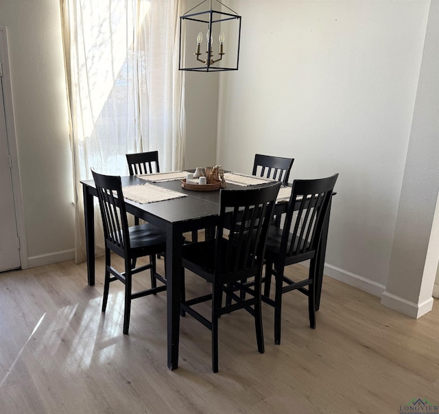 dining room featuring light hardwood / wood-style floors and an inviting chandelier