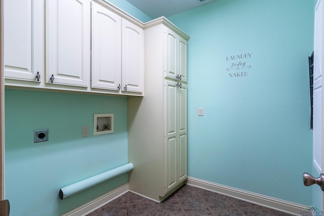 washroom with cabinets, washer hookup, dark tile patterned floors, and electric dryer hookup