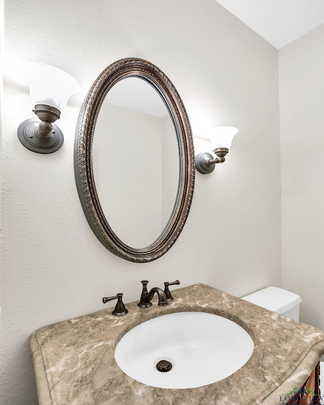 half bath featuring a sink and toilet